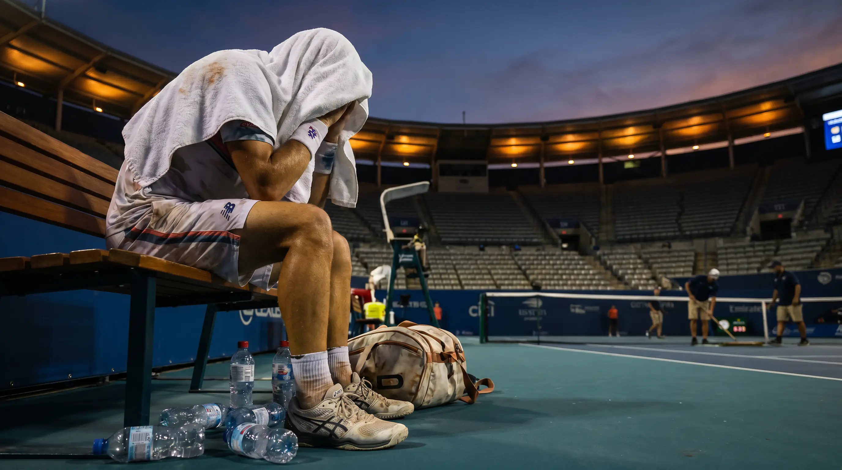 A player drained after a long three-set battle, illustrating accumulated fatigue between matches